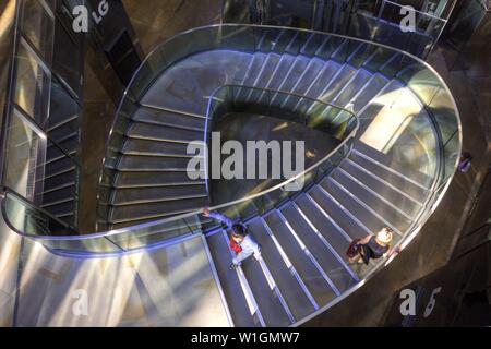 Un couple en train de marcher en sens inverse en escalier vers le haut ou vers le bas, à Londres, en Angleterre Banque D'Images