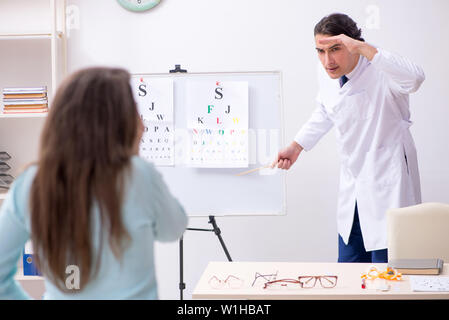 La jeune femme se rendant sur homme médecin oculiste Banque D'Images