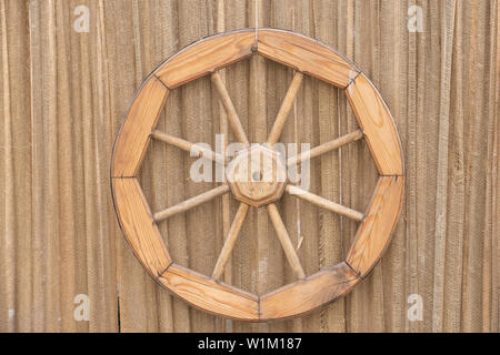 Description : Fragment d'un ancien mur avec une porte bleue, une vieille roue en bois et d'une gouttière Banque D'Images