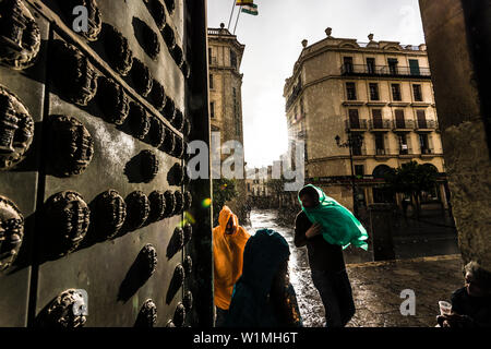 Les touristes au cours de la pluie à l'entrée latérale de la cathédrale dans le centre historique, Séville, Andalousie, province de Séville, Espagne Banque D'Images