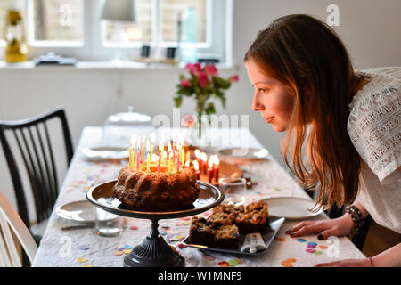 Teenage Girl blowing out candles on cake Partie à Hambourg, Allemagne Banque D'Images