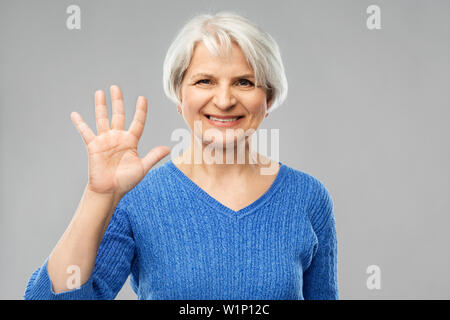 Young woman showing palm ou cinq doigts Banque D'Images