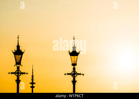 2 lampes Old street et la tour de télévision comme une silhouette dans la lumière au coucher du soleil, Hambourg, Allemagne Banque D'Images