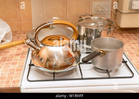 Casseroles, une poêle et une bouilloire sur la cuisinière à gaz Banque D'Images