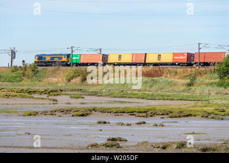 GB Railfreight Class 66 locomotive électrique diesel transportant un conteneur de marchandises sur la côte est de la grande ligne de chemin de fer près de Manningtree Anglia Banque D'Images