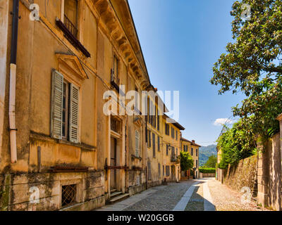 La rue déserte avec via et de murs en pierre à l'île de San Giulio sur le lac d'Orta Italie pendant un après-midi d'été Banque D'Images