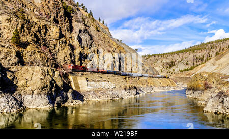 Les trains de marchandises à la suite de la Thompson et du Fraser le long des falaises et des tunnels dans le canyon du fleuve Fraser et Thompson, C.-B., Canada Banque D'Images