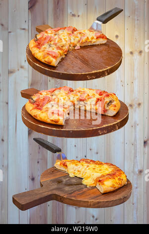 Pizza au jambon et fromage sur le plateau en bois est placé sur un fond de bois Banque D'Images
