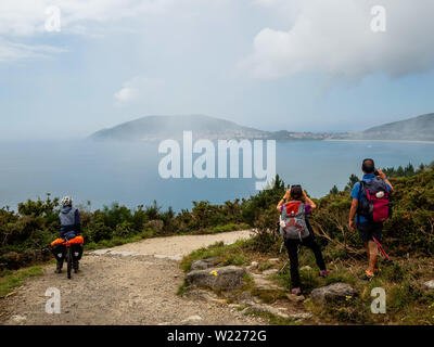 27 juin 2019 - Finisterra, un CoruÃ±a, Espagne - Les pèlerins sont vus à la prise de photos et pour la première fois le cap Finisterre. Le cap Finisterre est la destination de ces pèlerins qui, après avoir visité le tombeau de Saint James' est Santiago, continuent leur chemin le long du tracé pour eux par-dessus la Voie lactée jusqu'à ce qu'ils ne pouvaient faire plus. Finisterre a été examiné au cours de la période de l'Antiquité classique à la fin du monde connu. Finisterre, Fisterra ou en galicien, le dialecte de Galice, signifie ''Land's End'' en latin. Ensuite, pour le phare, il y a le 0.0 km Banque D'Images