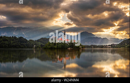 Bled, Slovénie - magnifique lever du soleil sur le lac de Bled Blejsko Jezero) (avec l'église de pèlerinage de l'assomption de Maria sur une petite île et Bl Banque D'Images