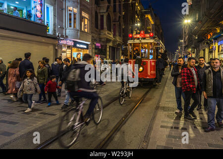 Les cyclistes à la suite de l'Istanbul tram rouge dans l'avenue Istiklal, la rue la plus importante du quartier de Beyoglu. Istanbul, Turquie, octobre 2018 Banque D'Images