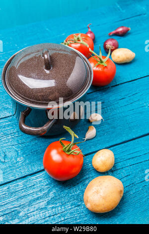 Photo du pot de fer, tomate, pomme de terre, oignon Banque D'Images