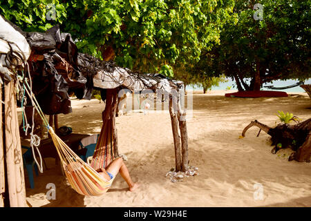 L'homme dans un hamac à l'extérieur d'un beach fale à Tonga. Banque D'Images