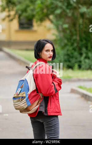 Fille de tourisme avec sac à dos en toile à la recherche de retour sur la rue Banque D'Images