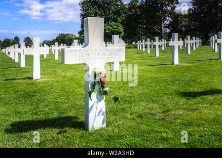 Soldat inconnu tombe avec croix blanche et de fleurs au D-Day Normandy American Cemetery, Colleville-sur-Mer, France. Banque D'Images