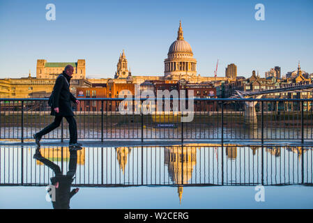 L'Angleterre, Londres, Southbank, personne reflète dans flaque, près du Millenium Bridge Banque D'Images