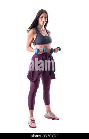 Athletic fit young woman in sportswear biceps bras faisant des exercices avec haltère. Corps plein isolé sur fond blanc. Banque D'Images