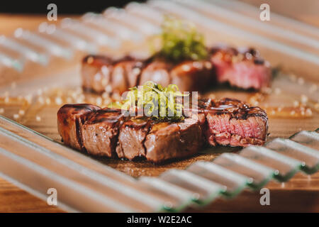 Steaks barbecue grillé aux herbes sur table en bois Banque D'Images