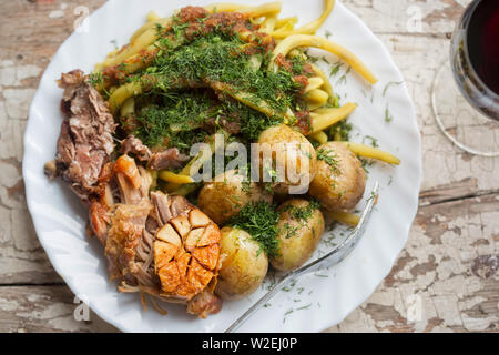 Rôti de porc aux pommes de terre, haricots verts et bébé Banque D'Images