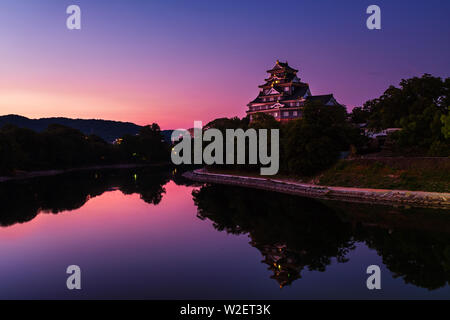 Okayama, Japon. Château à Okayama, Japon le matin avec river et coloré ciel violet au lever du soleil. Reflet dans l'eau Banque D'Images