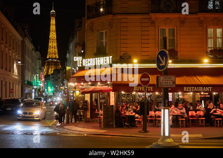 PARIS - 8 NOVEMBRE 2018 : Tour Eiffel illuminée la nuit et avec les gens de la rue et restaurant typique de Paris, France Banque D'Images