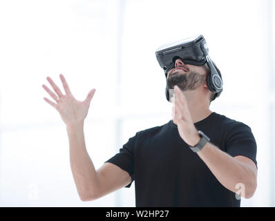 Portrait d'un homme stupéfait à l'aide d'un casque de réalité virtuelle isolée Banque D'Images