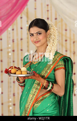 Portrait of a woman holding pooja thali Stock Photo