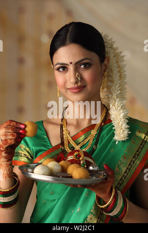 Portrait of a woman holding pooja thali Stock Photo