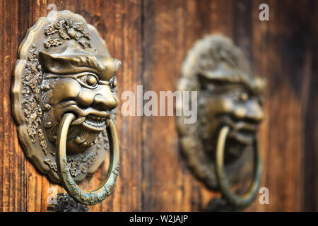 Rouge antique portes avec clous dorés et tête de lion heurtoirs de porte Banque D'Images