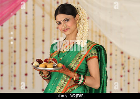 Portrait of a woman holding pooja thali Stock Photo