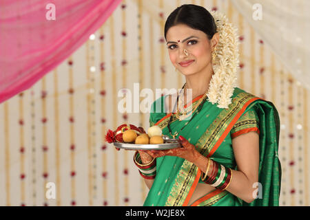 Portrait of a woman holding pooja thali Stock Photo