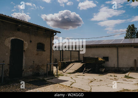 Photo de panneaux solaires sur le toit d'une ancienne étable dans une ferme à la campagne Banque D'Images