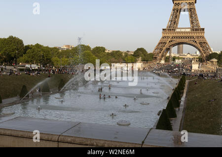 Europe, France, Paris, 2019-06, Tour Eiffel monument viewd gardins du Trocadéro. Les gens se baigner dans les fontaines, dans le but de refroidir duri Banque D'Images