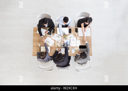 Vue de dessus du businessman sitting at conference table lors de réunion d'équipe, chefs d'établissement de liaison faisant partie de la collaboration au démarrage Banque D'Images