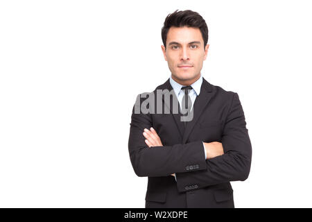 Portrait d'un charmant man dressed in suit posing while standing arms crossed and looking at camera isolated over white background Banque D'Images