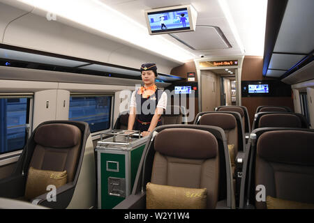 (190711) -- CHONGQING, 11 juillet 2019 (Xinhua) -- Un accompagnateur travaille à bord du train rapide G319 à la gare de l'ouest de Chongqing dans le sud-ouest de la Chine, Chongqing, le 11 juillet 2019. Le bullet train G319 a quitté la gare de l'ouest de Chongqing à 8 h 20 et arrivera à Hong Kong West Kowloon Station autour de 7,5 heures plus tard. Un siège de seconde classe pour les 7,5 heures de voiture coûte 660 yuans (environ 96 dollars américains). (Xinhua/Tang Yi) Banque D'Images