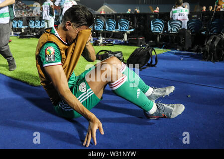 Suez, Egypte. 11 juillet, 2019. L'Algérie a Bagdad Bounedjah réagit après le coup de sifflet final de la coupe d'Afrique des Nations 2019 Quart de finale match de football entre la Côte d'Ivoire et l'Algérie au stade sportif de Suez. Credit : Oliver Weiken/dpa/Alamy Live News Banque D'Images