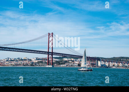 Le 25 avril pont sur la rivière Tagus avec un voilier à Lisbonne, Portugal Banque D'Images