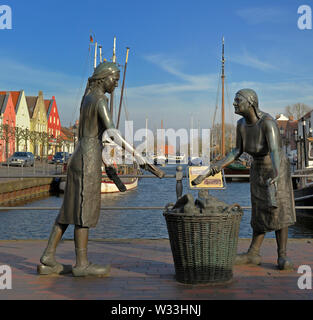 Weener, Niedersachsen, Allemagne - 03 avril, 2013 - sculpture de Karl Ludwig boeke de deux femmes pierres tourbières dans un panier pour leur voyage à th Banque D'Images