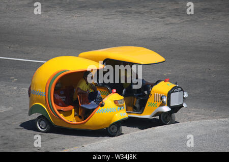 La Havane, Cuba - 2 juillet 2019 Pilote : se détendre dans leur 'Coco Taxi', un mode de transport populaire à Cuba. Banque D'Images