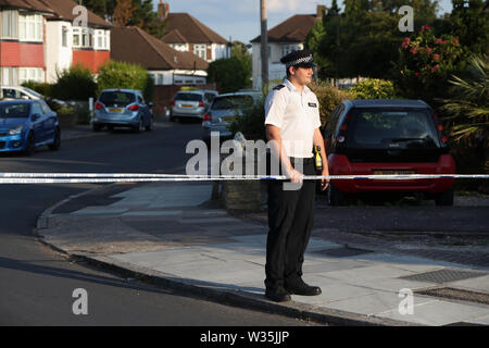 Un agent de police à un cordon près d'Aarschot Avenue à Whitton, sud-ouest de Londres, où deux personnes, un homme dans son 60s et une femme dans son 70s, a été trouvé poignardé à mort. Banque D'Images