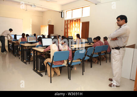 School children using computers in computer lab Stock Photo