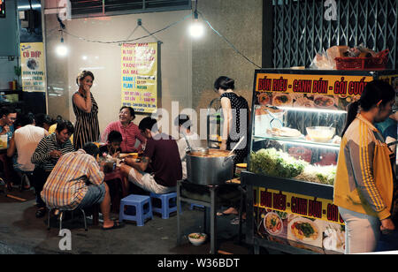 Groupe des diners de manger au restaurant en plein air nuit à l'alimentation de rue, ambiance animée sur la rue quand les gens vont à l'heure de dîner, Vietnam Banque D'Images