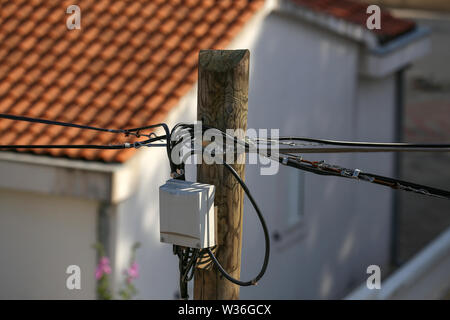 Boîte de distribution sur un poteau électrique en bois. Banque D'Images