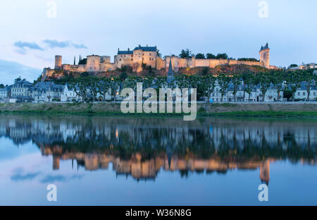 Chinon, France. Crépuscule pittoresque vue de la Vienne à Chinon, avec la Forteresse illuminée Royal et Fort Saint George, dans l'arrière-plan. Banque D'Images