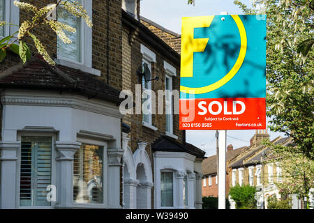 Foxtons immobilier vendu signe à l'extérieur des maisons mitoyennes à Londres Angleterre Royaume-Uni Royaume-Uni Banque D'Images
