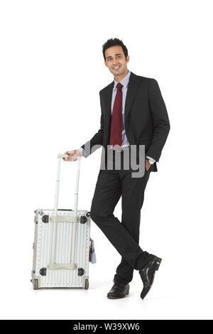 Businessman standing with suitcase Banque D'Images