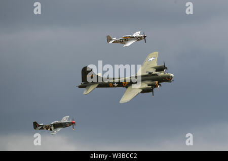 The UK's last navigabilité B-17 Flying Fortress 'Sally B' est flanqué d'une paire de Curtiss P-40 Warhawk Flying Legends pendant l'Air Show à Duxford IWM. Banque D'Images