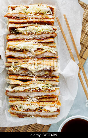 Katsu Sando-japonais traditionnel sandwich escalope de porc frit avec du chou,japonais,la mayonnaise et la sauce tonkatsu sur un fond clair close-up Banque D'Images