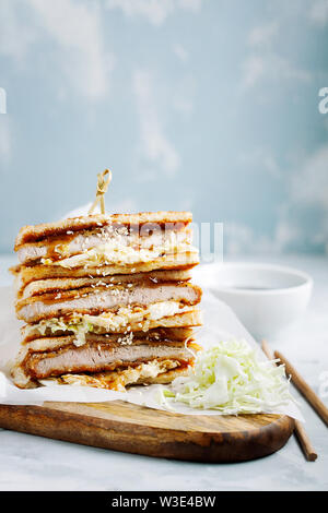 Katsu Sando - escalope traditionnelle japonaise avec sandwich porc frit chou,japonais,la mayonnaise et la sauce tonkatsu sur un fond clair close-up Banque D'Images